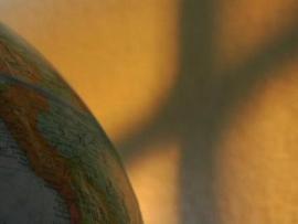 Picture of a globe with the shadow of a cross
